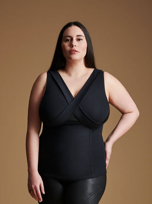 Woman wearing black sleeveless v neck top.
