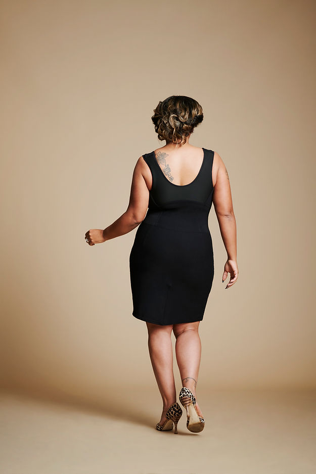 Back view of woman wearing black dress.