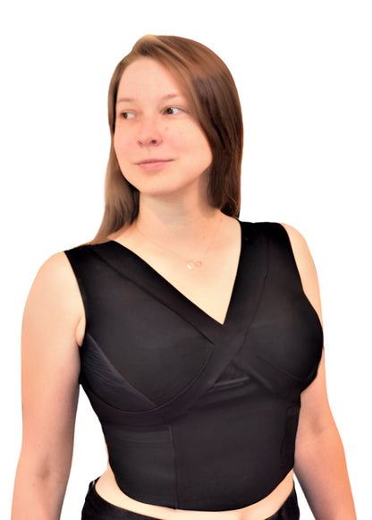 Woman wearing black waist length crop top and black exercise pants.
