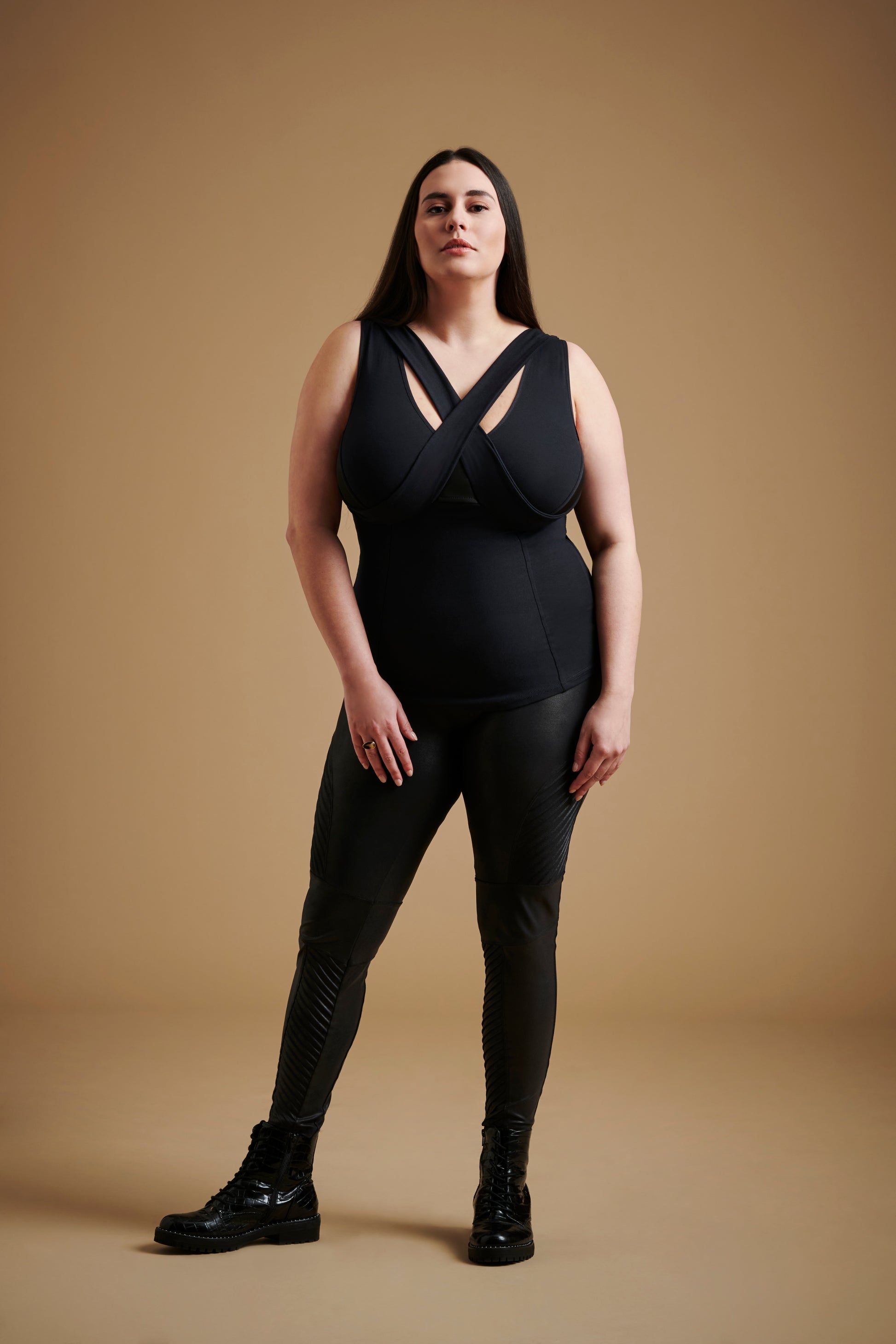 Woman wearing black sleeveless v neck top and black pants.