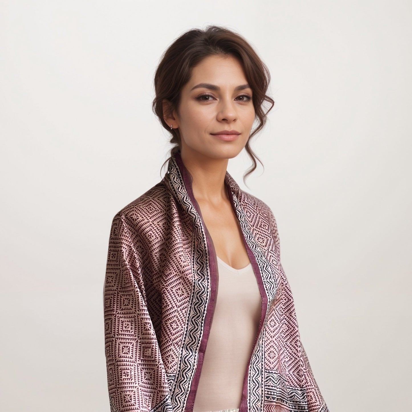 Woman wearing red, natural, and black scarf with a square pattern.
