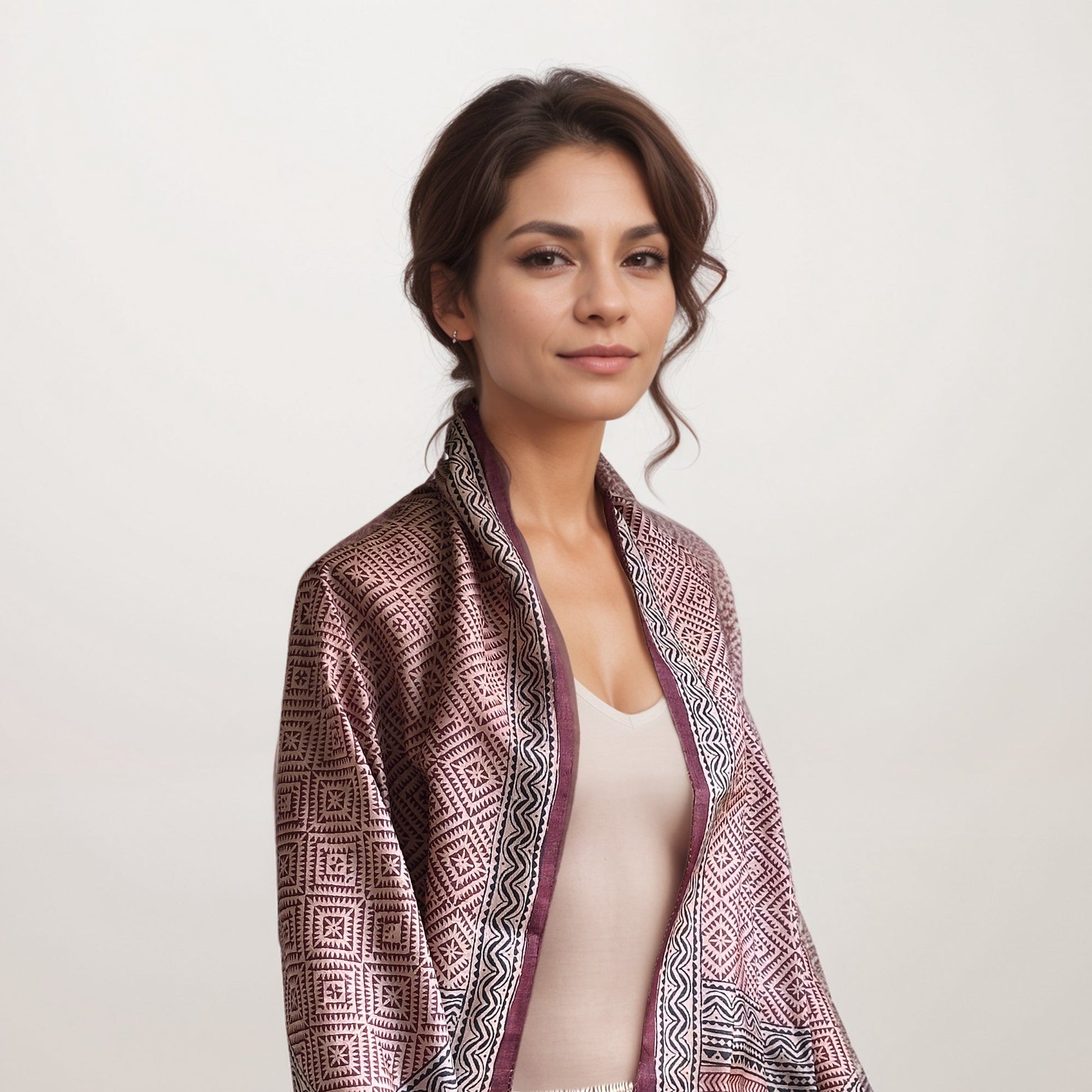 Woman wearing red, natural, and black scarf with a square pattern.