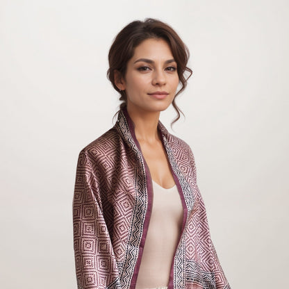 Woman wearing red, natural, and black scarf with a square pattern.