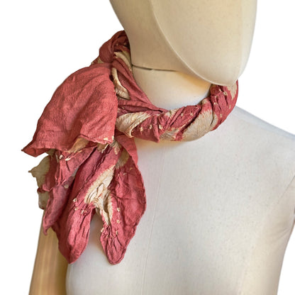 Mankikin model wearing tie dye scarf twisted and tied to the right.