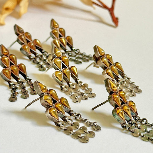 Grouping of gold foil post earrings with tribal design.