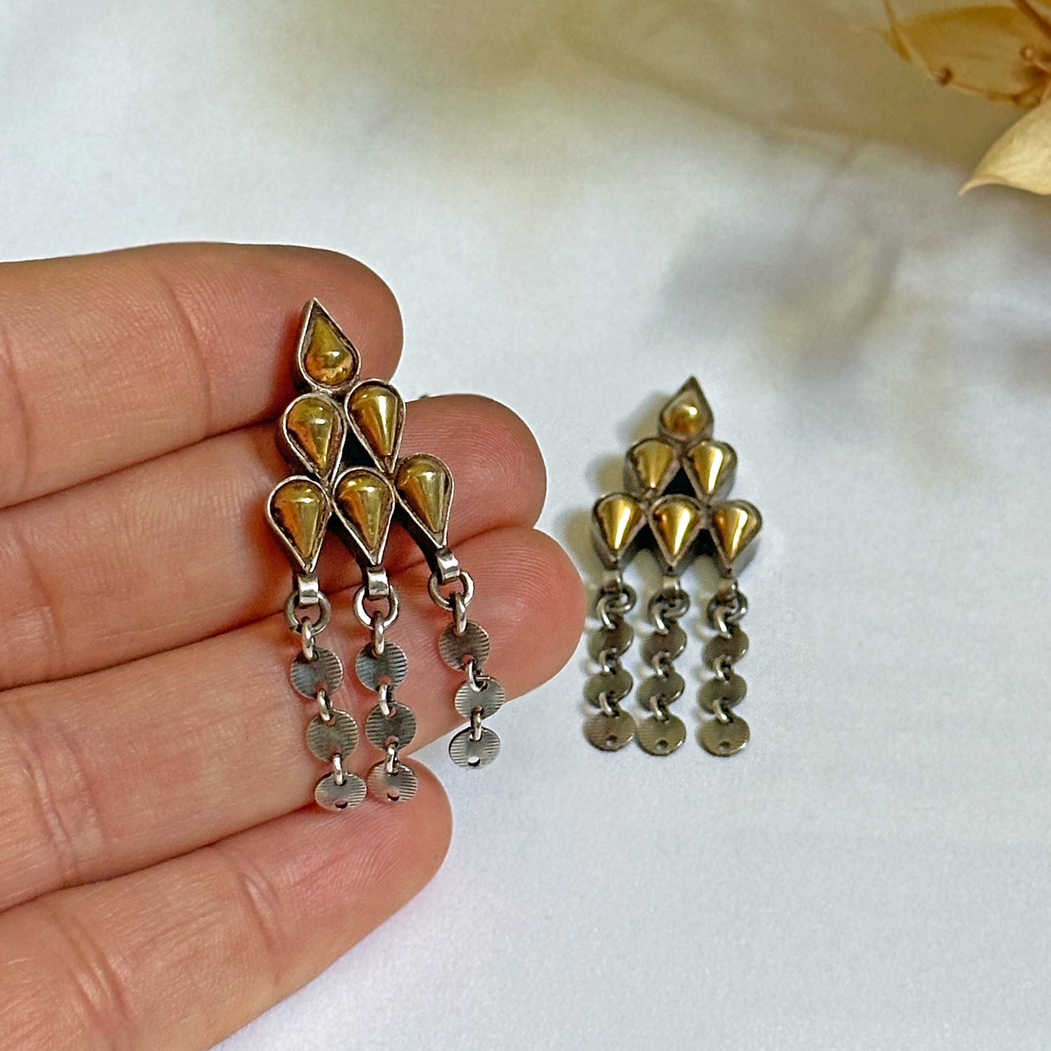 Pair of gold foil post earrings with tribal design.