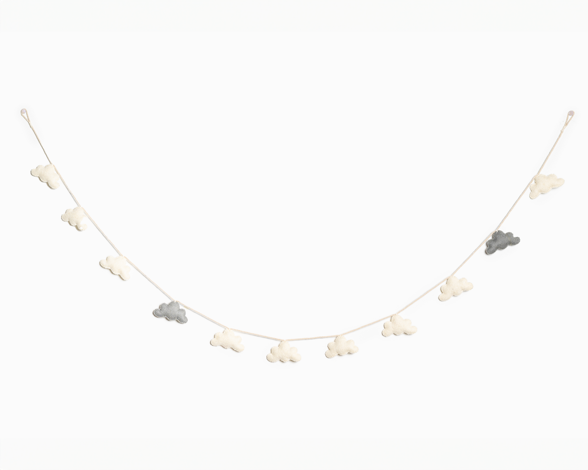 Grey and white felt cloud garland hanging on a white wall.