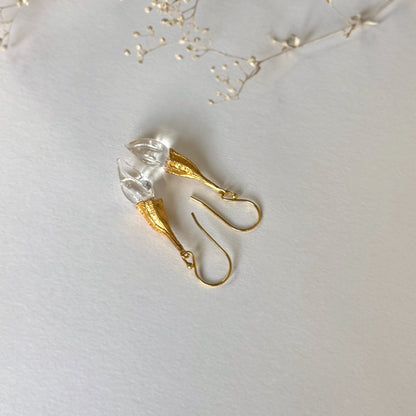 Pair of clear twisted glass bud earrings with gold findings.