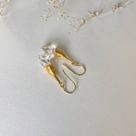 Pair of clear twisted glass bud earrings with gold findings.