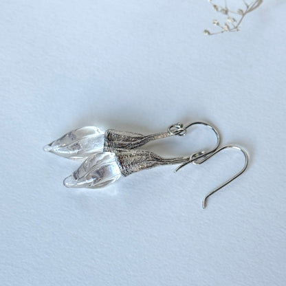 Pair of clear twisted glass bud earrings with silver findings.