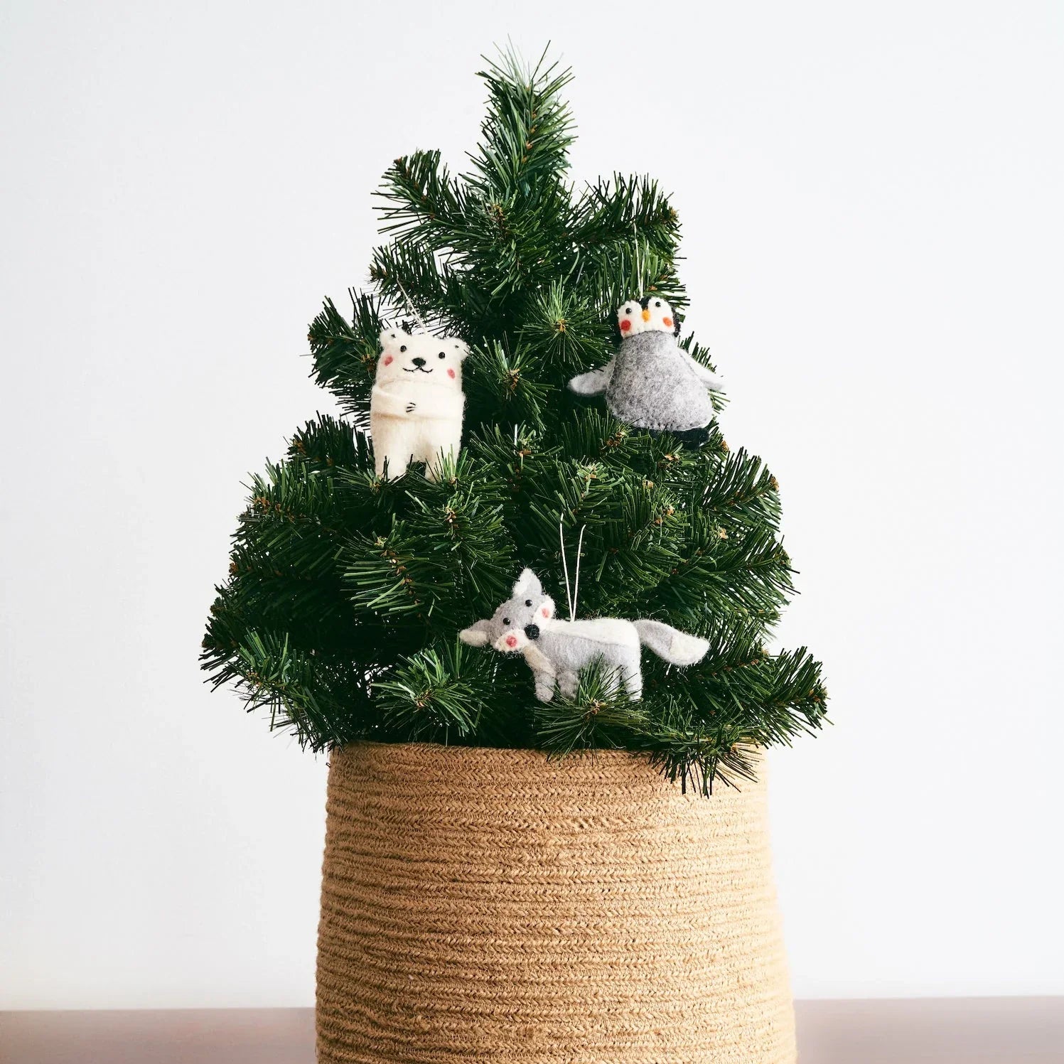Mini Christmas tree with ornaments of felted wool arctic animals.