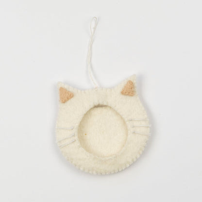 Felt ornament of a white cat face outline with a frame in the middle to put a photograph.