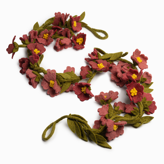 Felt garland of pink cherry blossoms and green leaves.