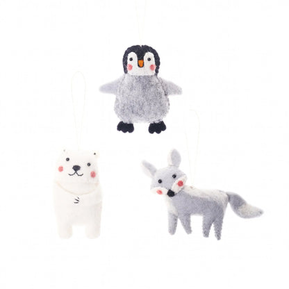 Felted arctic animal ornaments of a penguin, a polar bear, and a fox.