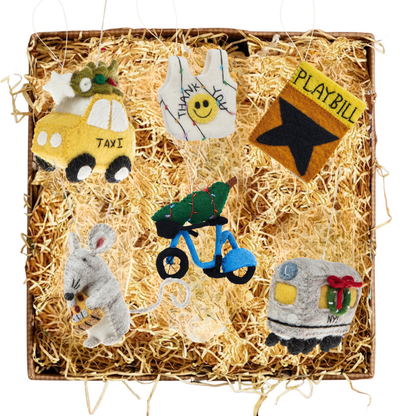 New York City themed felt Christmas ornaments featuring a taxi with Christmas tree, a smiley face thank you bag, a playbill, a to go coffee cup, a mouse with cheese, a Citi Bike with Christmas tree, and a metro train car.