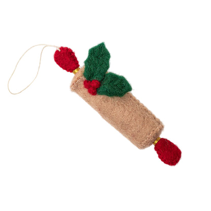 Felt ornament of a tan rolling pin with holly leaves and berries attached.