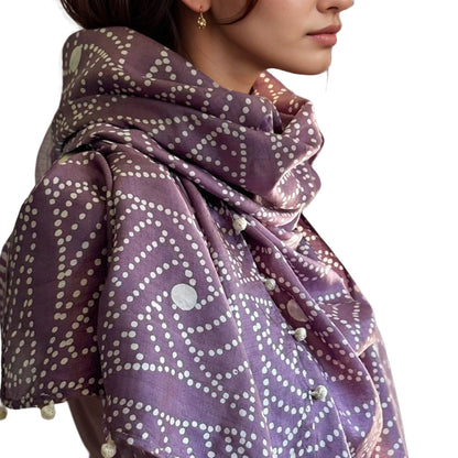 Right side closeup view of woman wearing purple and natural scarf.