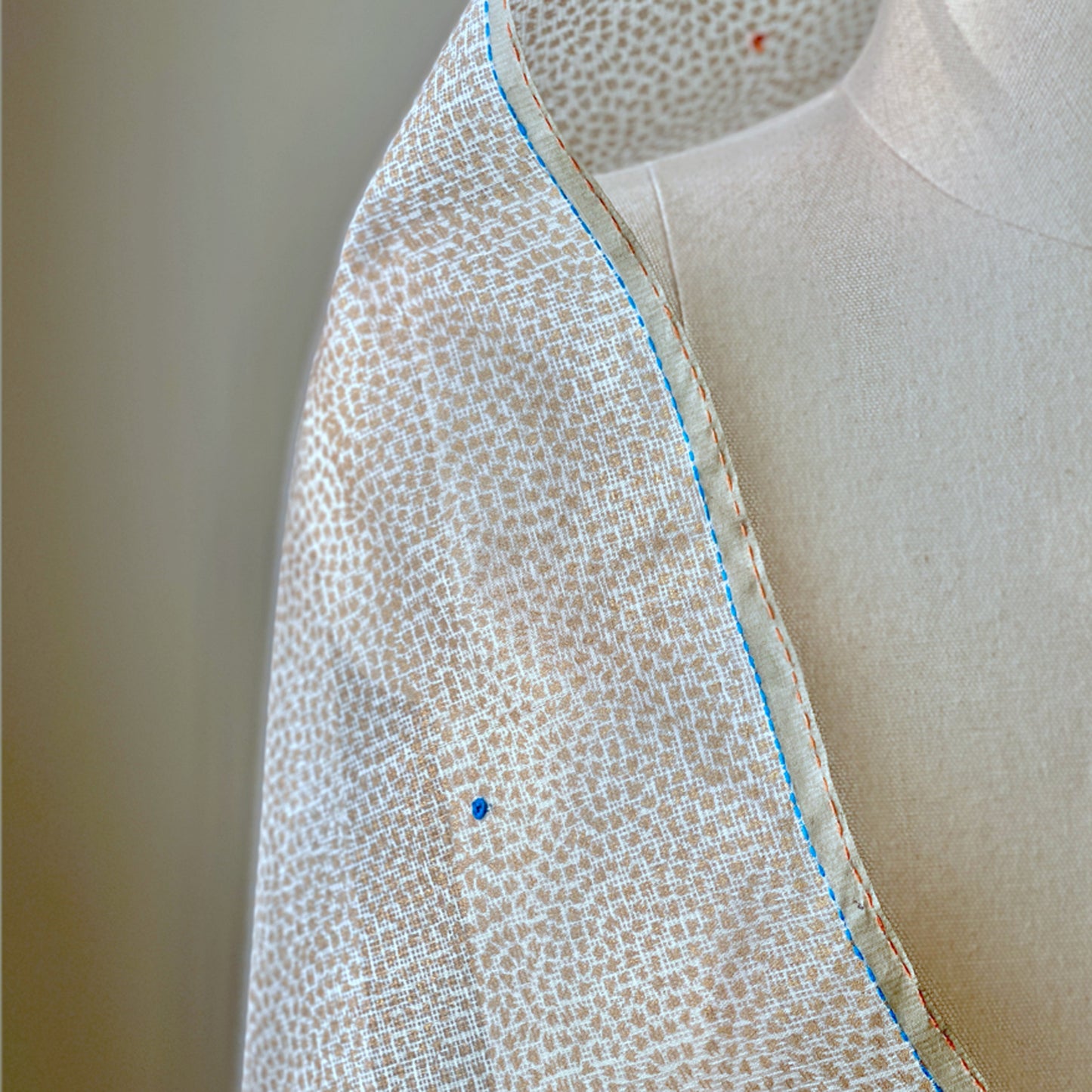 White and light brown dotted shoulder wrap.