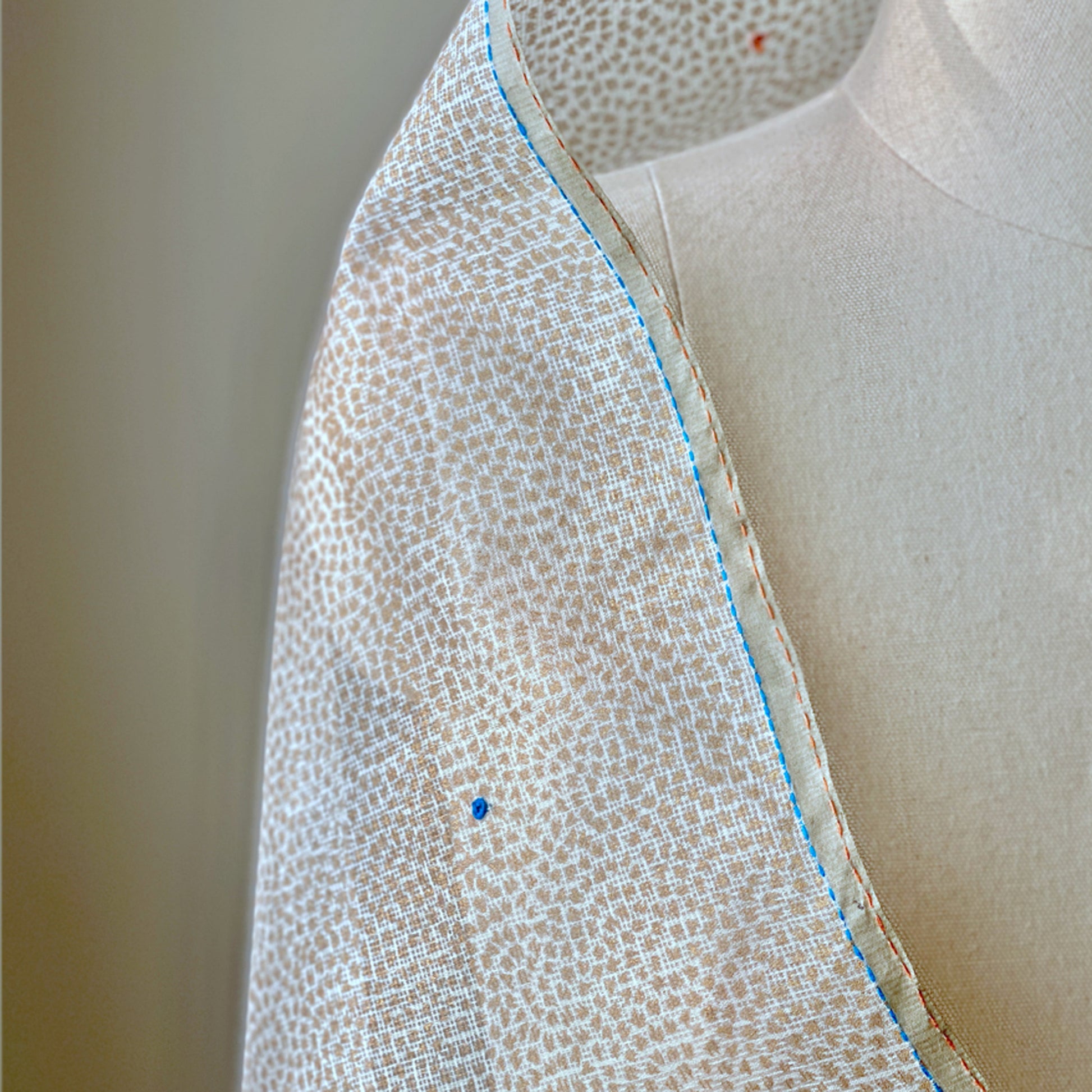 White and light brown dotted shoulder wrap.