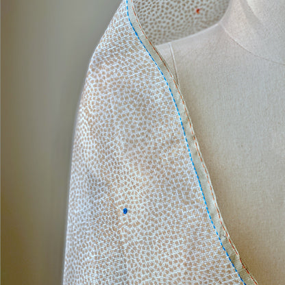 White and light brown dotted shoulder wrap.