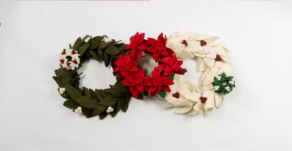Felt ornaments of mini wreaths in green, red, and white.
