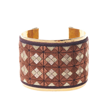 Artisan gold plated cuff bracelet with reddish brown and tan embroidery design.