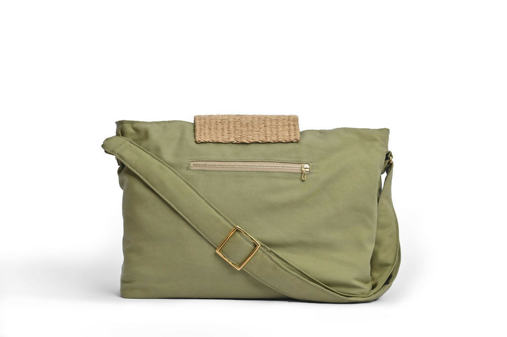 Back view of large green bag with sisal details, zipper pocket, and strap.