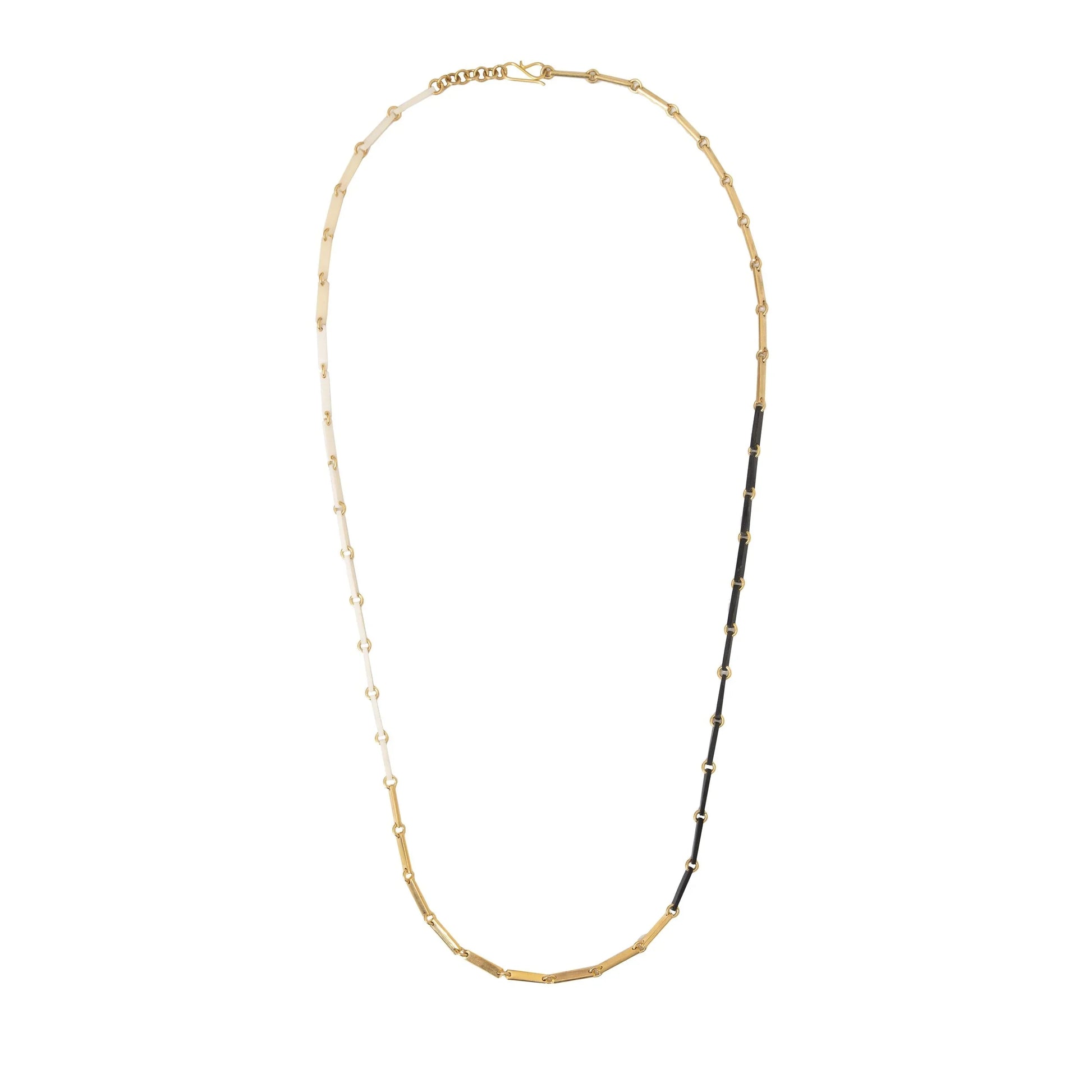 White, gold, and black link necklace on a white background.