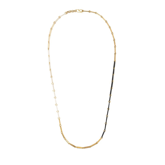 White, gold, and black link necklace on a white background.