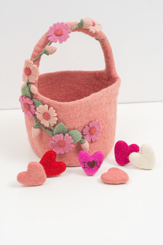 Handmade pink felt basket with floral and heart decorations on a white background | Global Goods Partners