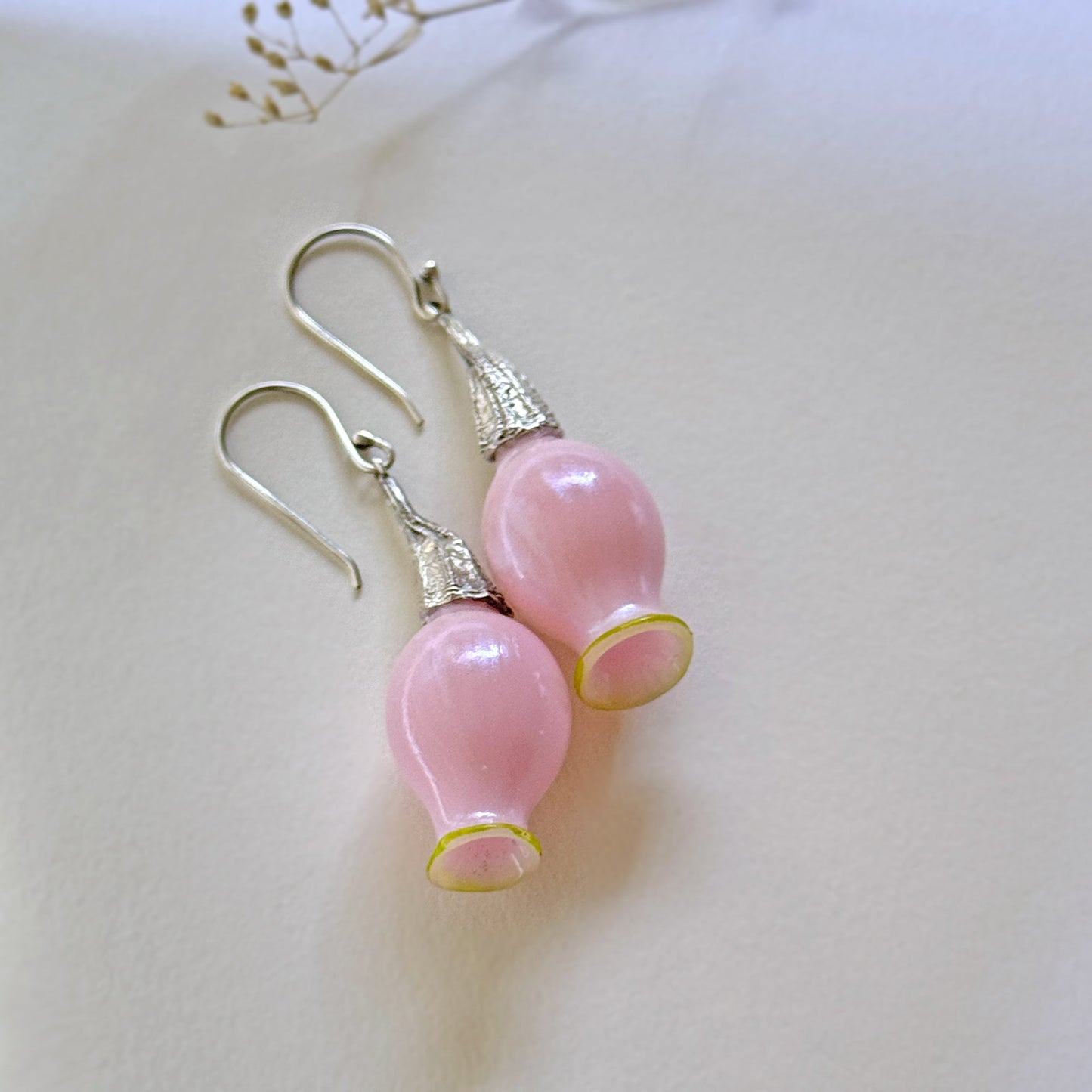 Pair of iridescent pink pod glass bud earrings with silver findings.