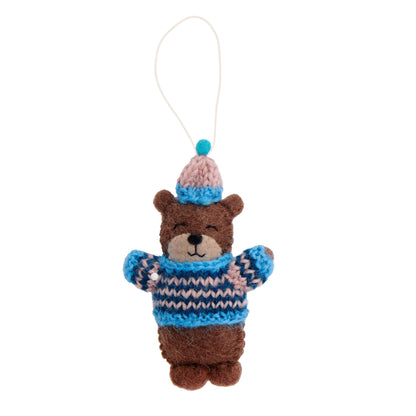Felt ornament of a bear in a blue and pink striped knitted sweater and hat.