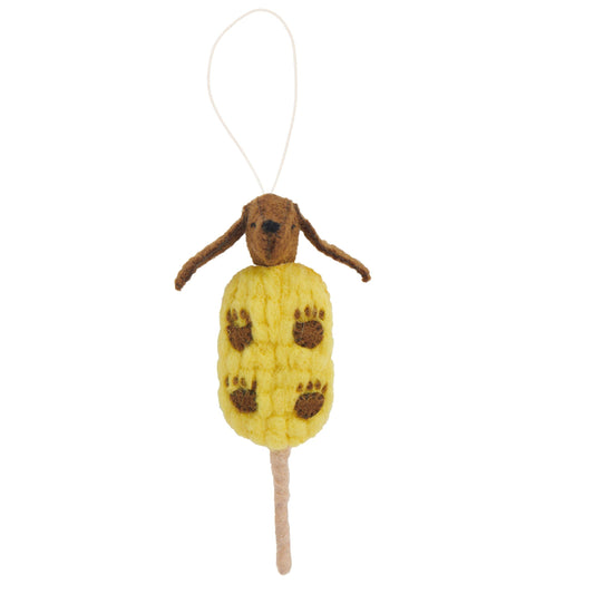 Felt ornament of a brown dog in a yellow corn on a stick.
