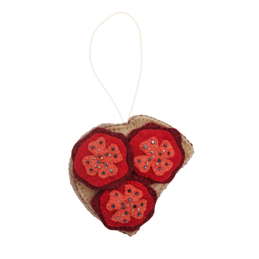 Felt ornament of three tomato slices on toast.