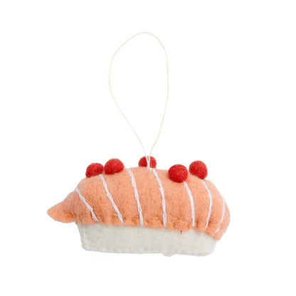Felt ornament of salmon on rice sushi piece.