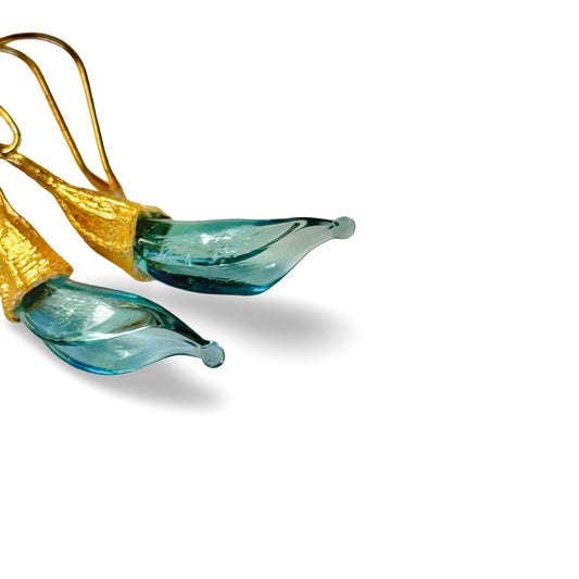 Pair of blue twisted glass petal earrings with gold findings.