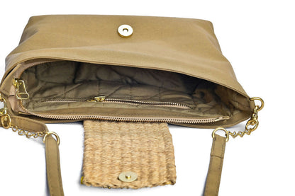 Closeup inside view of sandstone green bag with brass details and open flap..