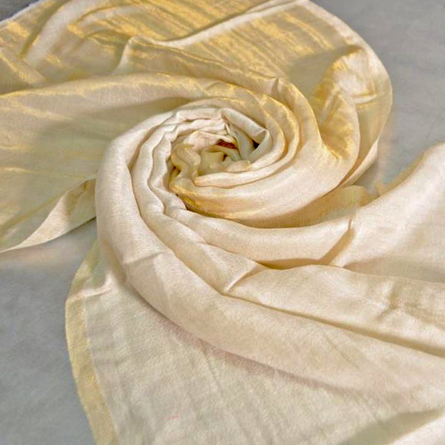 Twisted gold shimmering wrap on flat surface.