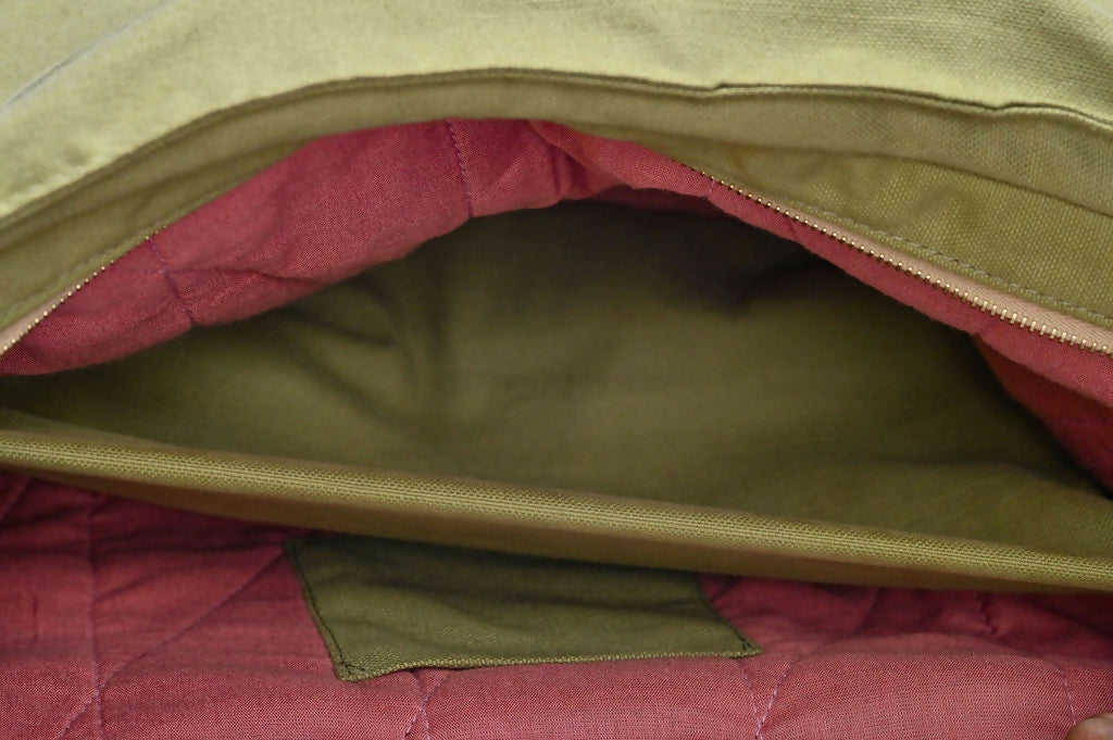 Closeup of inside large green bag with sisal details with pink lining.