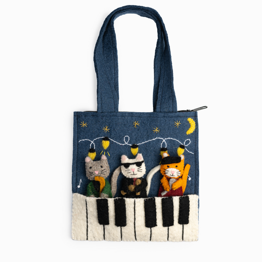 Felt Jazz Cats Puppet Bag features three finger puppets: a singing cat with a beret, a drummer cat with sunglasses, and a saxophone-playing cat.  The bag itself has piano keys, string lights, stars, and a glowing moon.