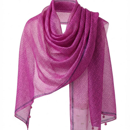 Pink Kota silk scarf in rose magenta with small block-printed floral motifs and hand-knotted marigold and charcoal tassels, hanging on a white background.