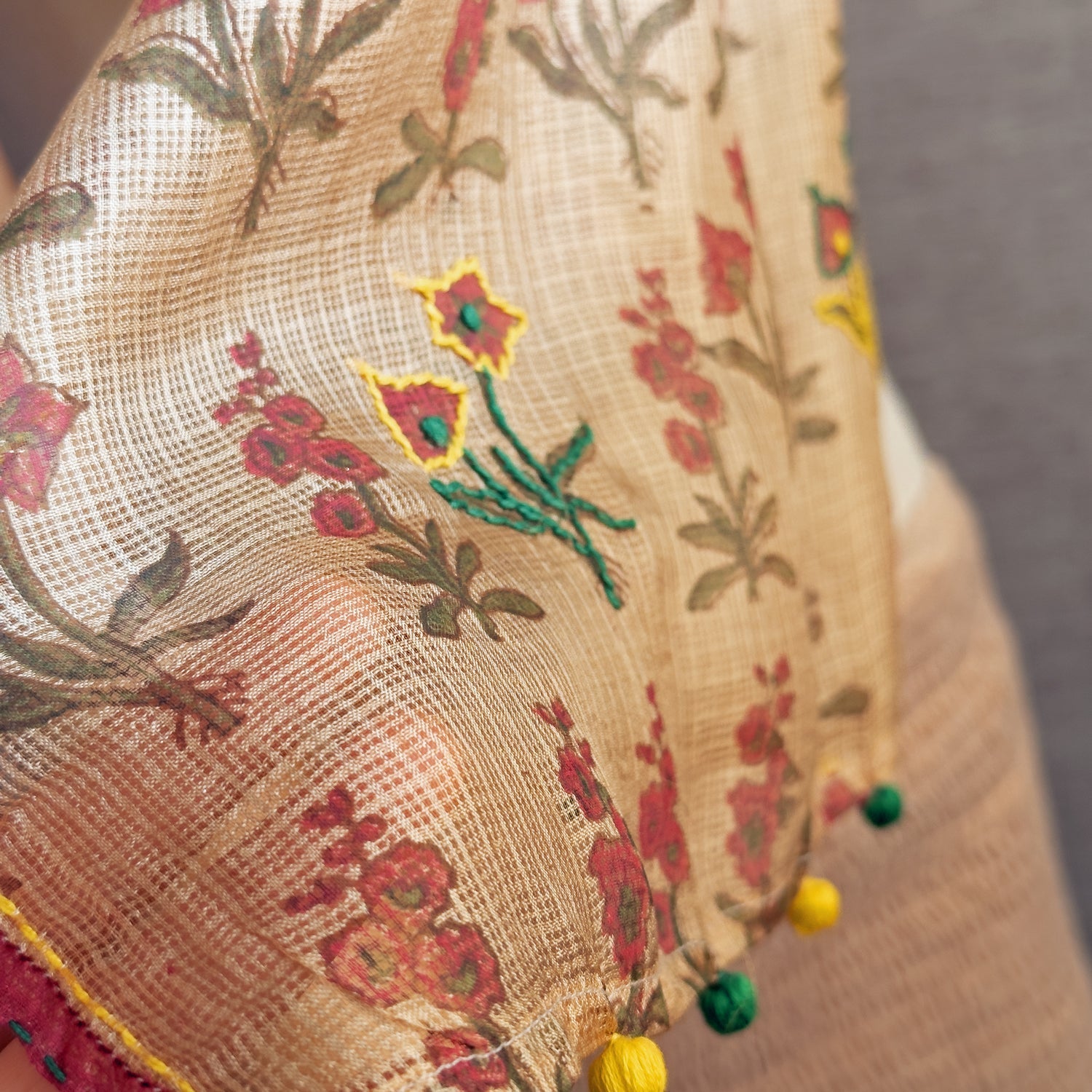Closeup of natural died silk stole with pink, green, yellow flowers.