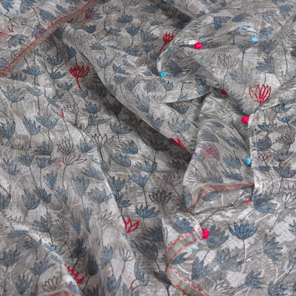 Closeup of white with pinkish red and blue flowered shoulder wrap.