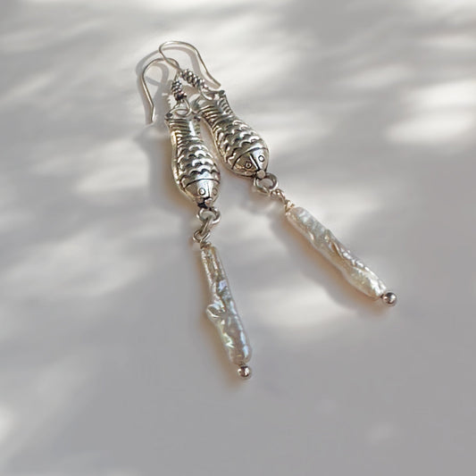 Silver and pearl dangle earings with fish motif.