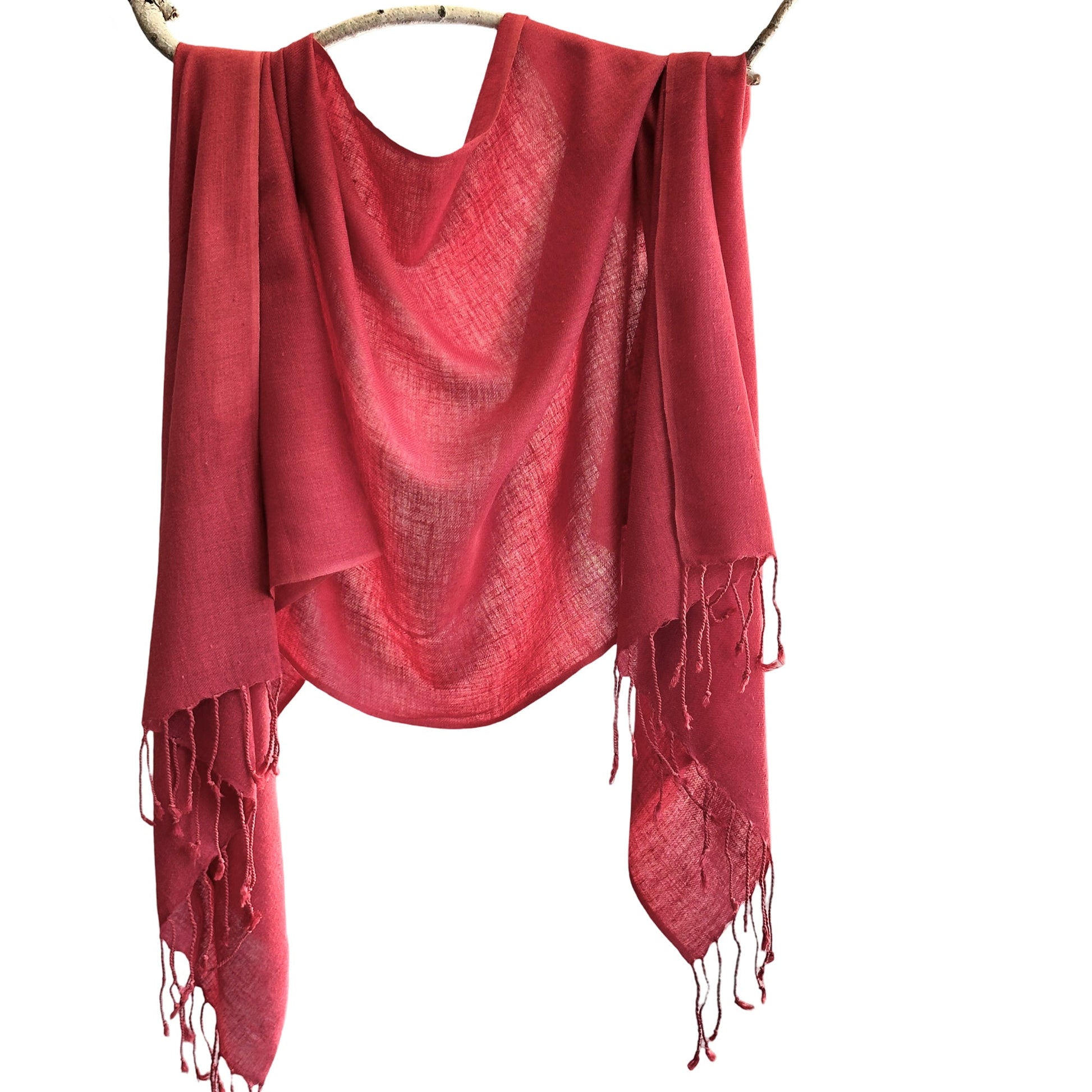 Red silk scarf draped over branch.