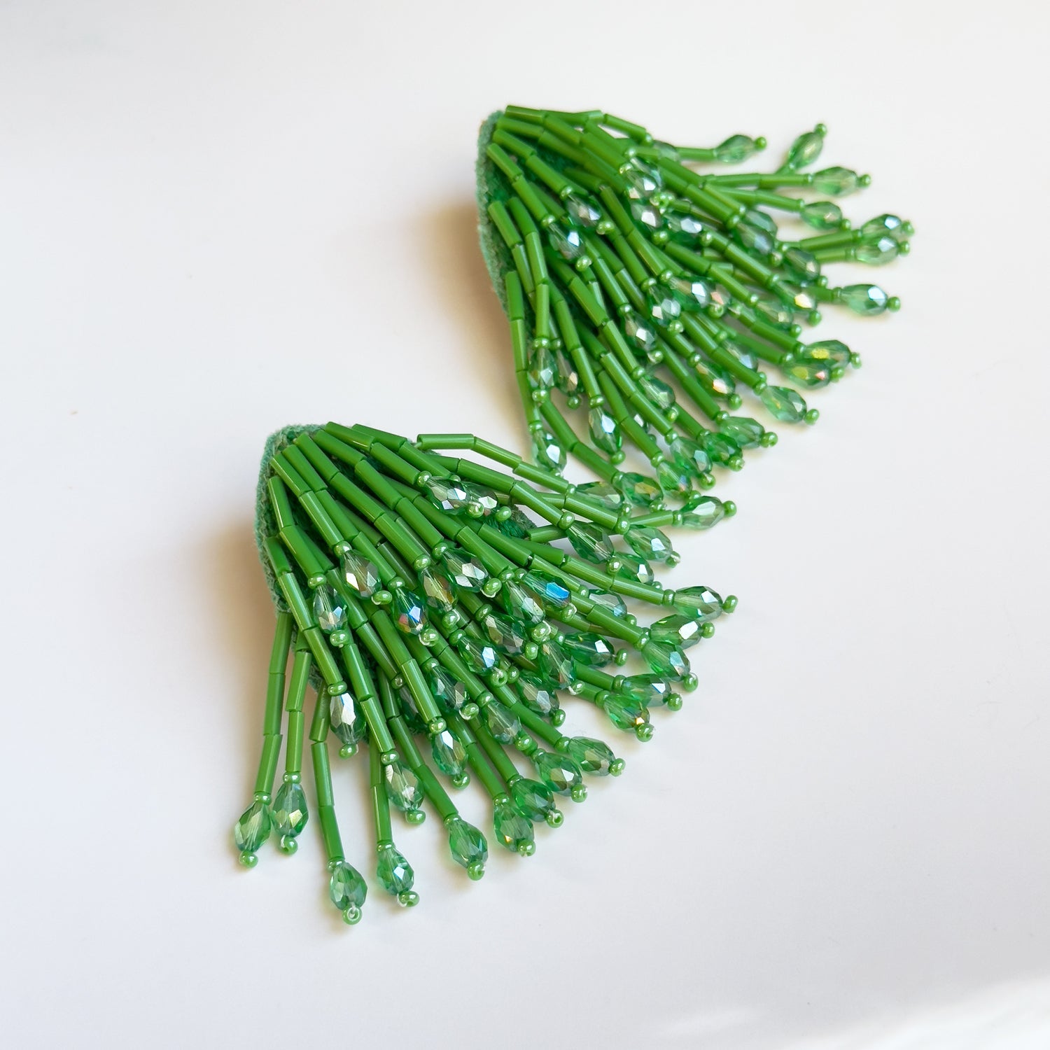 Pair of beaded green glass tassel earrings.