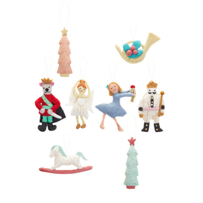 Felt ornament of a French Horn with a sprig of holly and berries with other various Nutcracker themed ornaments.