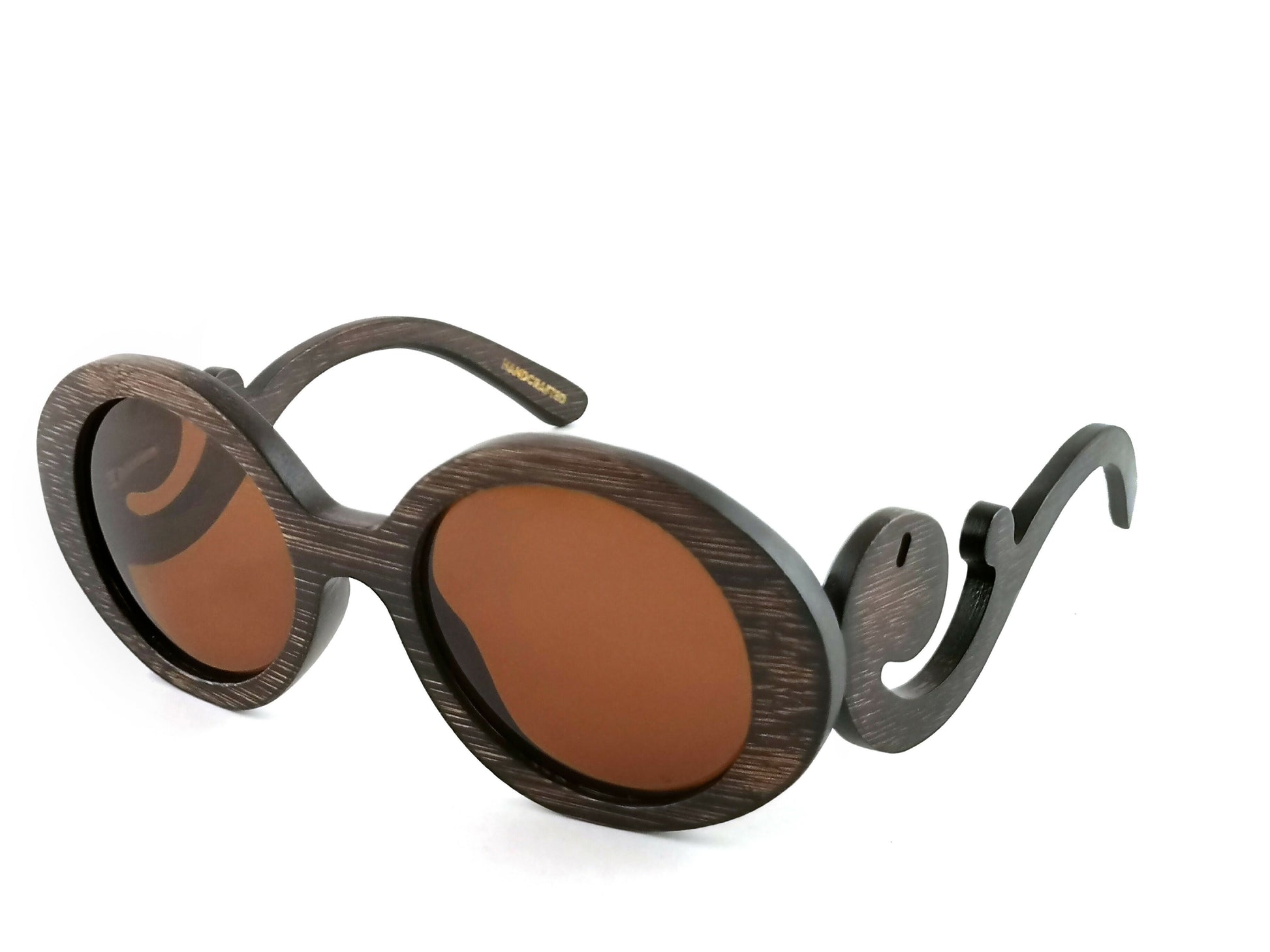 Brown bamboo sunglasses with brown lenses with scroll like design on arms.
