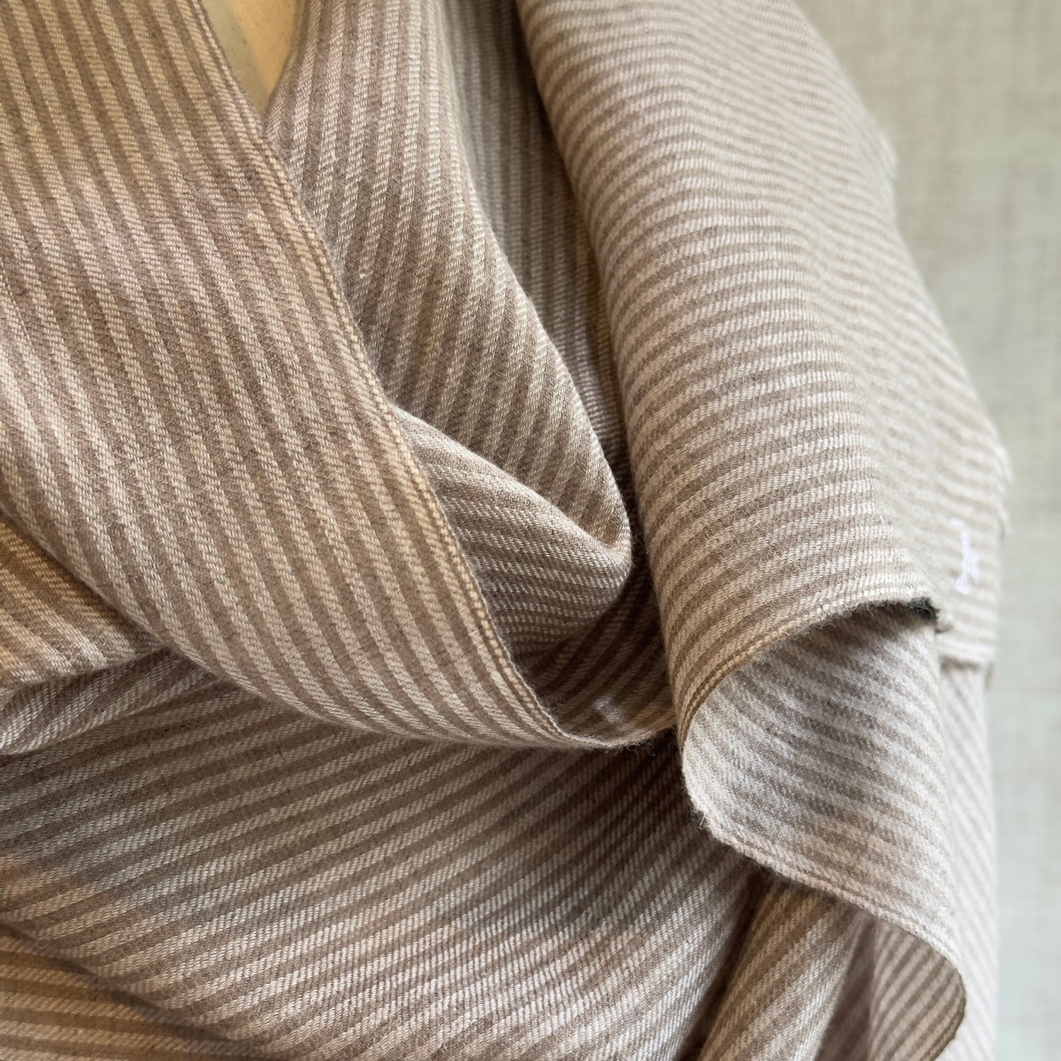Closeup of taupe and brown striped scarf material.