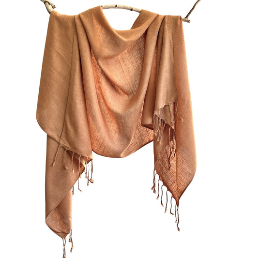 Light brown scarf draped on branch.